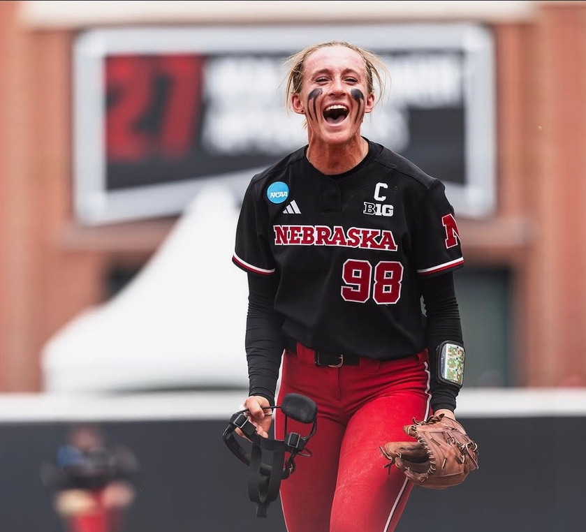 Softball player celebrating in a Nebraska uniform